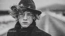 Stylish Young Man in Wide-Brimmed Hat and Wool Coat in Winter Scene