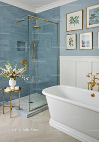 Elegant bathroom with blue tiled shower and freestanding tub