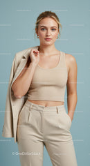 Elegant Young Woman in Beige Crop Top and Suit Posing Confidently