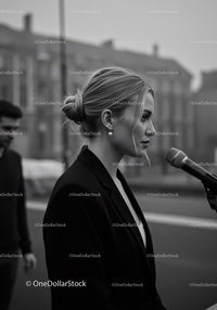 Stylish Woman in Black Blazer Speaking Outdoors in City