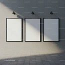 Three Blank Vertical Frames on Textured Concrete Wall