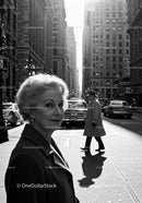 Elegant Elderly Woman Walking in Black and White City Street Scene