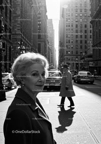 Elegant Elderly Woman Walking in Black and White City Street Scene