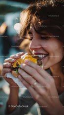 Happy Woman Eating Cheeseburger in Outdoor Setting