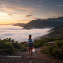 Hiker Overlooking Mountain Range During Sunrise with Clouds and Fog