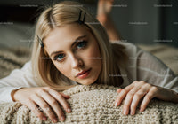 Young Woman with Blue Eyes and Blonde Hair in Cozy Indoor Setting