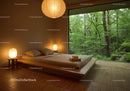 Minimalist bedroom with large window overlooking lush forest