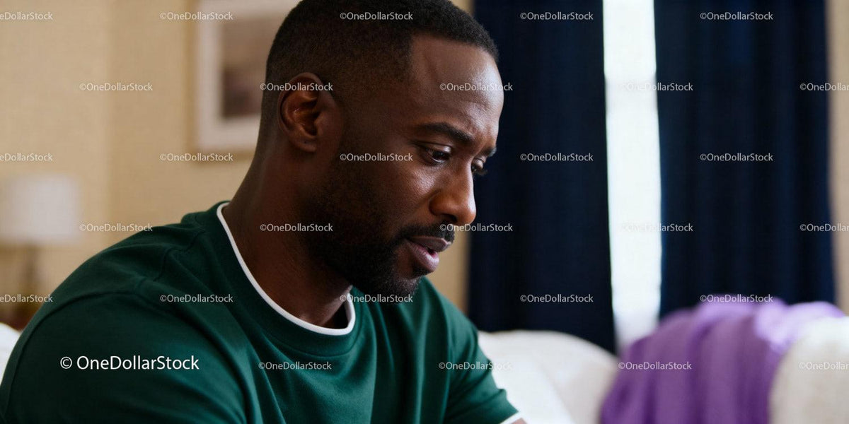 Thoughtful young man reflecting in quiet home setting