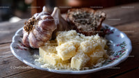 Fresh Garlic Cheese and Bread on Rustic Wooden Table