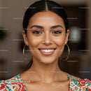 Portrait of a Smiling Woman with Dark Hair and Gold Hoop Earrings
