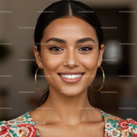 Portrait of a Smiling Woman with Dark Hair and Gold Hoop Earrings
