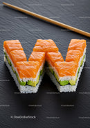 Fresh salmon avocado sushi pieces arranged like letter W