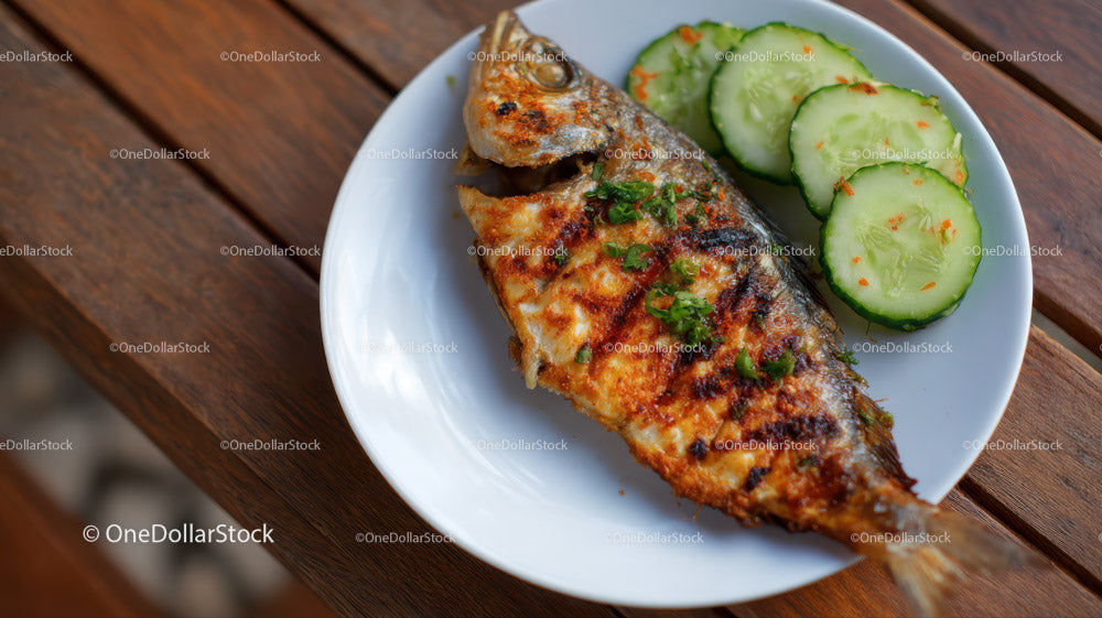 Grilled Fish with Cucumber Slices on Rustic Wooden Table