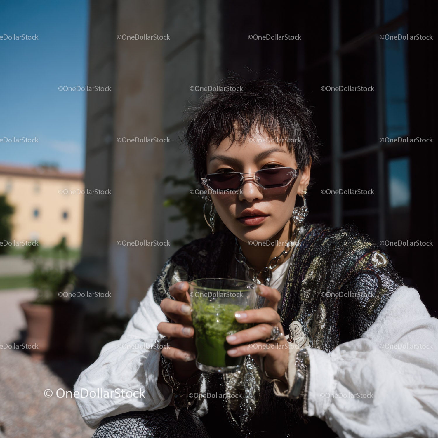 Fashionable Young Woman with Sunglasses Holding Green Smoothie Outdoors