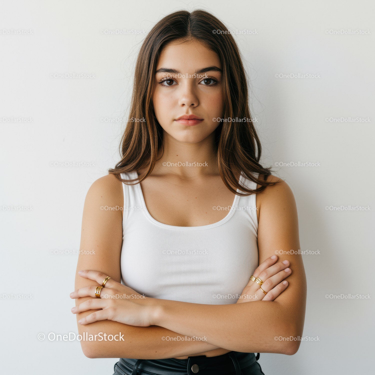 Confident Young Woman with Crossed Arms in Casual White Tank Top