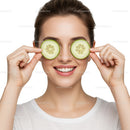 Happy Woman with Cucumber Slices Over Eyes for Relaxing Skincare