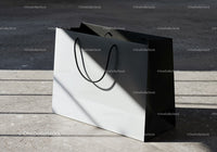 Minimalist white and black shopping bag in sunlight