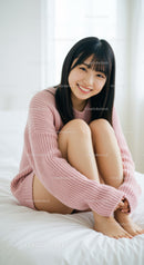 Young Woman in Pink Sweater Sitting on Bed in Bright Room