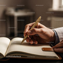 Business Professional Writing with Gold Pen in a Notebook in Office