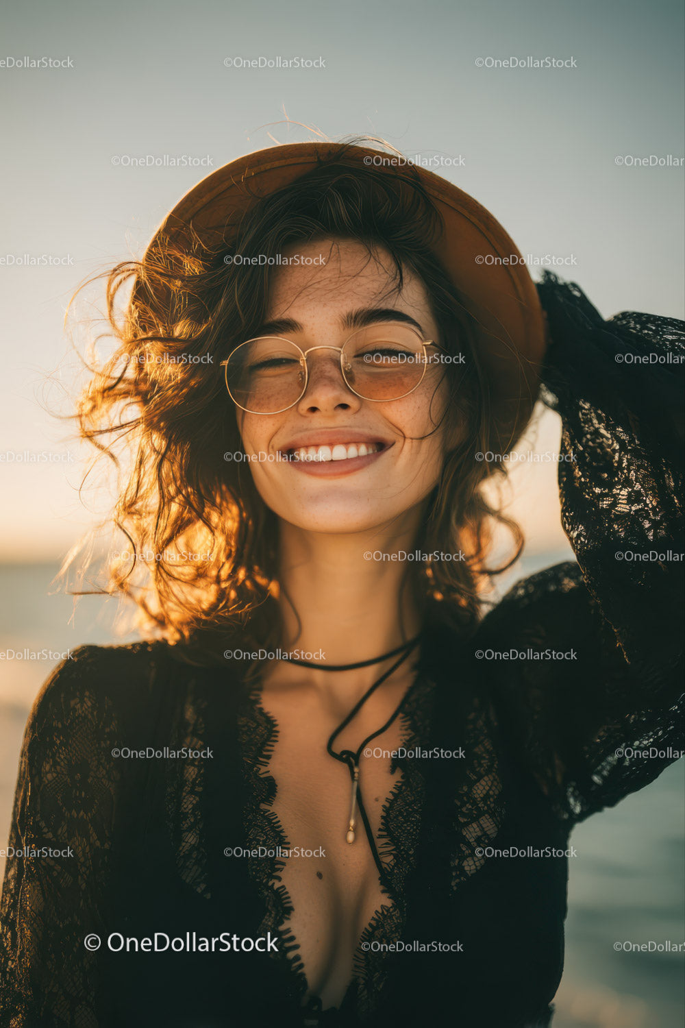 Young Woman Smiling at Sunset on the Beach in Stylish Summer Outfit