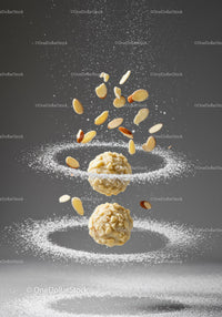 Almond coated truffles with flying nut slices and powdered sugar