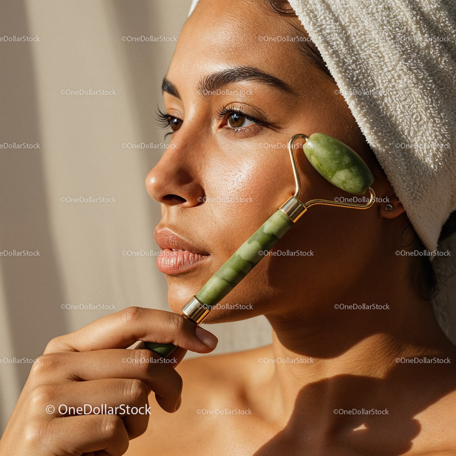 Elegant Woman Receiving Facial Massage with Jade Roller for Skin Rejuvenation
