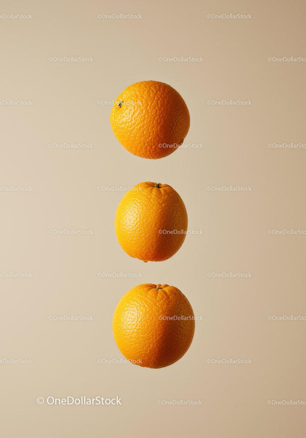 Three Fresh Oranges Floating on Neutral Background
