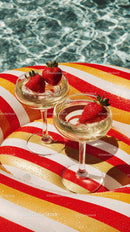Strawberry Cocktails on a Floating Pool Lounger in Bright Summer Scene