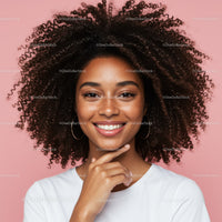 Young Woman with Curly Hair Smiling Portrait on Pink Background