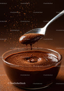Spoon lifting rich chocolate mousse with cocoa dust