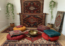 Cozy meditation space with cushions and brass singing bowl