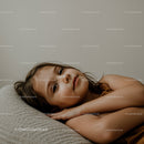 Serene Young Girl Relaxing on Couch in Cozy Home Environment