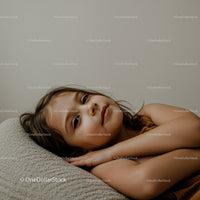 Serene Young Girl Relaxing on Couch in Cozy Home Environment