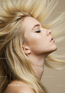 Blonde woman with flowing hair and closed eyes