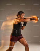Focused female boxer delivering a powerful punch