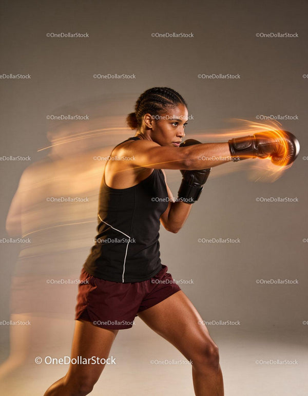 Focused female boxer delivering a powerful punch