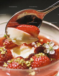 Creamy dessert with fresh strawberries and crushed pistachios