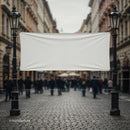 Blank white banner hanging between vintage street lamps