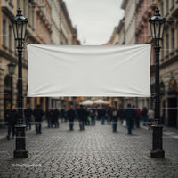Blank white banner hanging between vintage street lamps