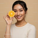 Young Woman Holding Fresh Orange Citrus Fruit Brightens Up Studio Setting