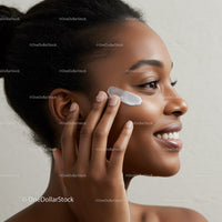 Young Woman Applying Facial Moisturizer for Healthy Skin