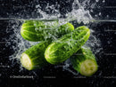 Fresh Green Cucumbers Sliced with Water Splash in a Dynamic Food Shot