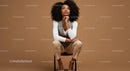 Confident Woman Sitting on a Chair with Thoughtful Expression in Brown Background