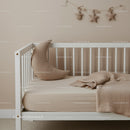 Minimalist toddler bed with cozy moon pillow and blanket