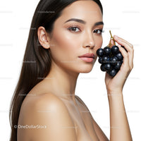 Elegant Woman with Black Grapes in a Fresh Portrait