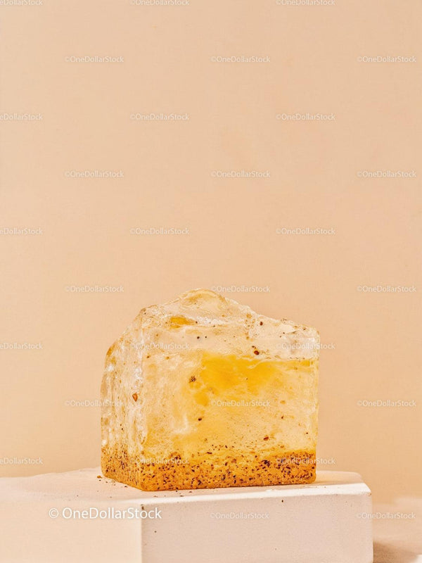 Transparent amber resin cube with organic inclusions