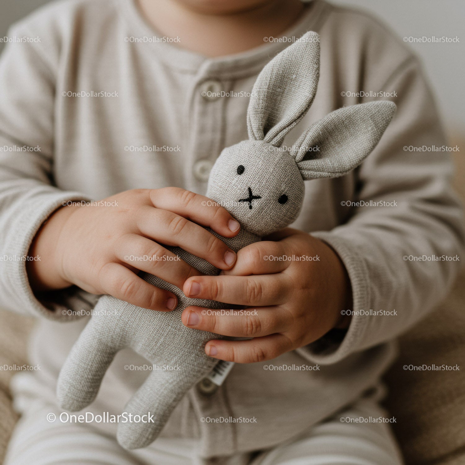 Child Holding Soft Fabric Bunny Toy Close Up