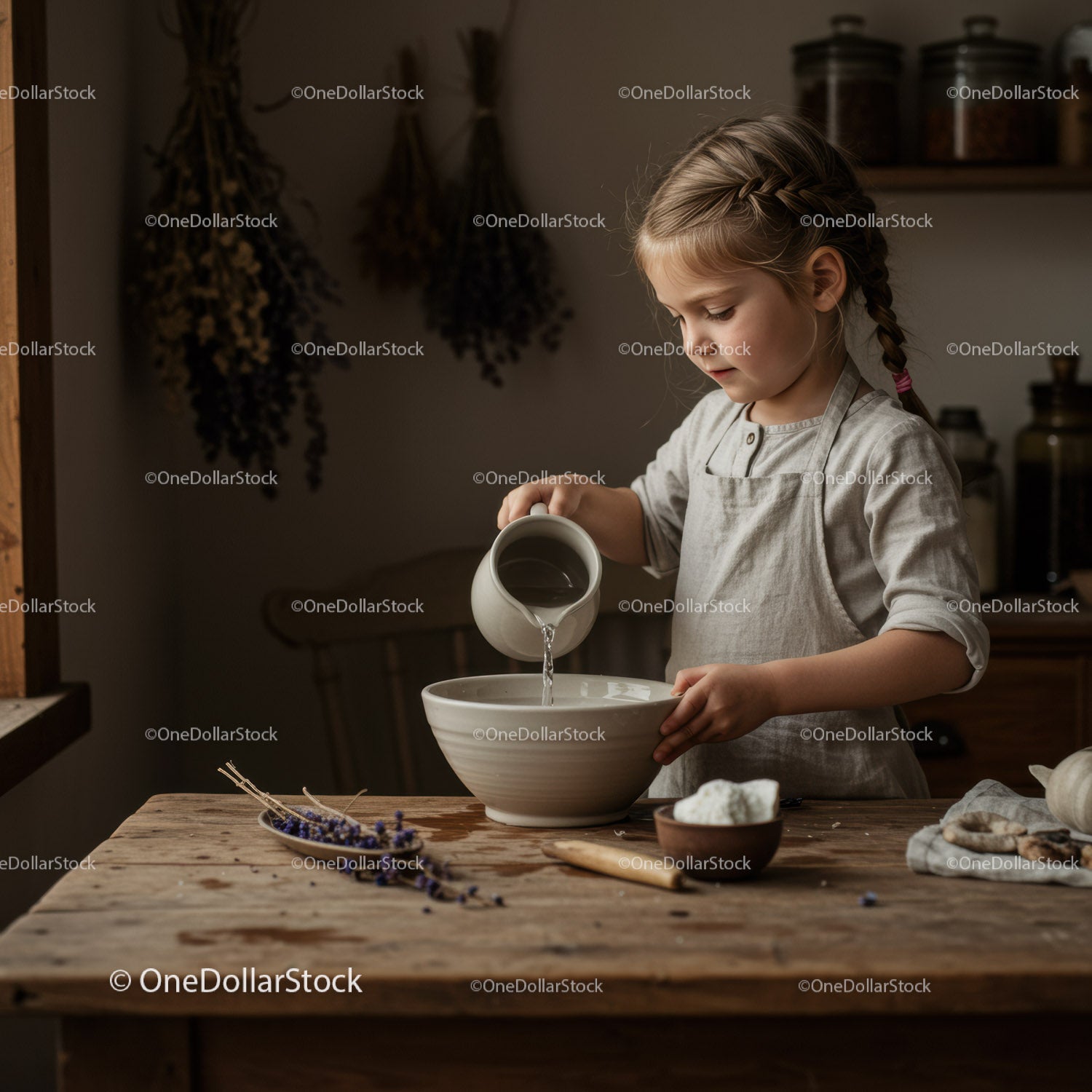 Little girl pouring water into bowl in rustic kitchen