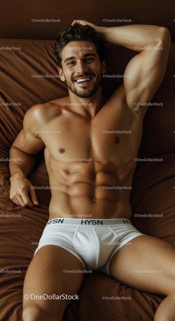 Smiling muscular man relaxing on bed in white underwear