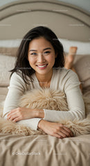 Young woman smiling comfortably on cozy bed